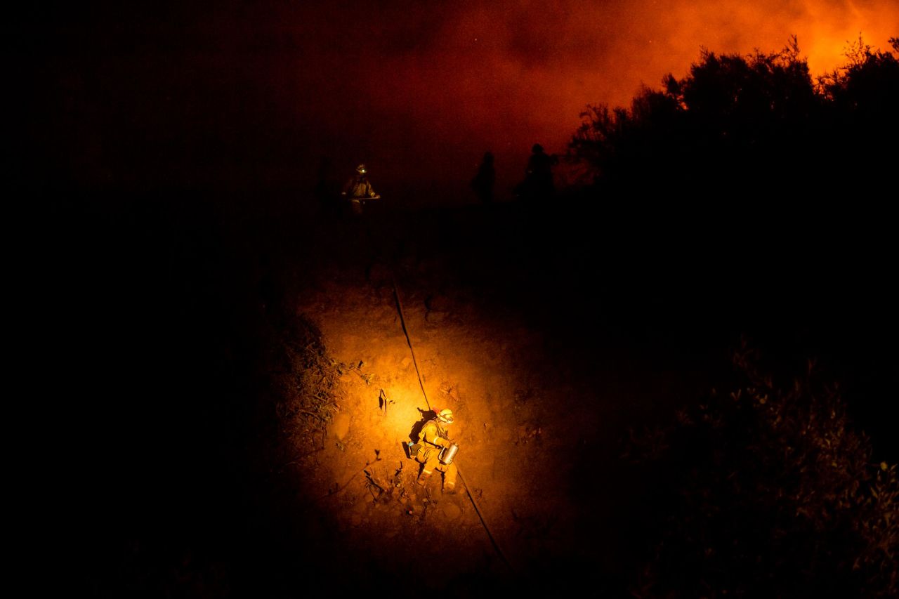 A firefighter makes his way down a hillside while battling the Mendocino Complex Fire on August 7.