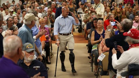 Rep. Brian Mast salutes as he arrives for a town hall meeting in Fort Pierce, Florida.