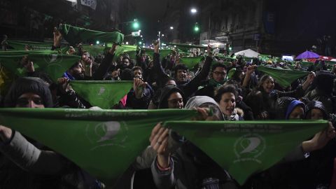 Pro-choice activists hold green banners as they demonstrate outside Congress on Thursday.