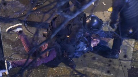 Riot police agents arrest a demonstrator outside the Congress.