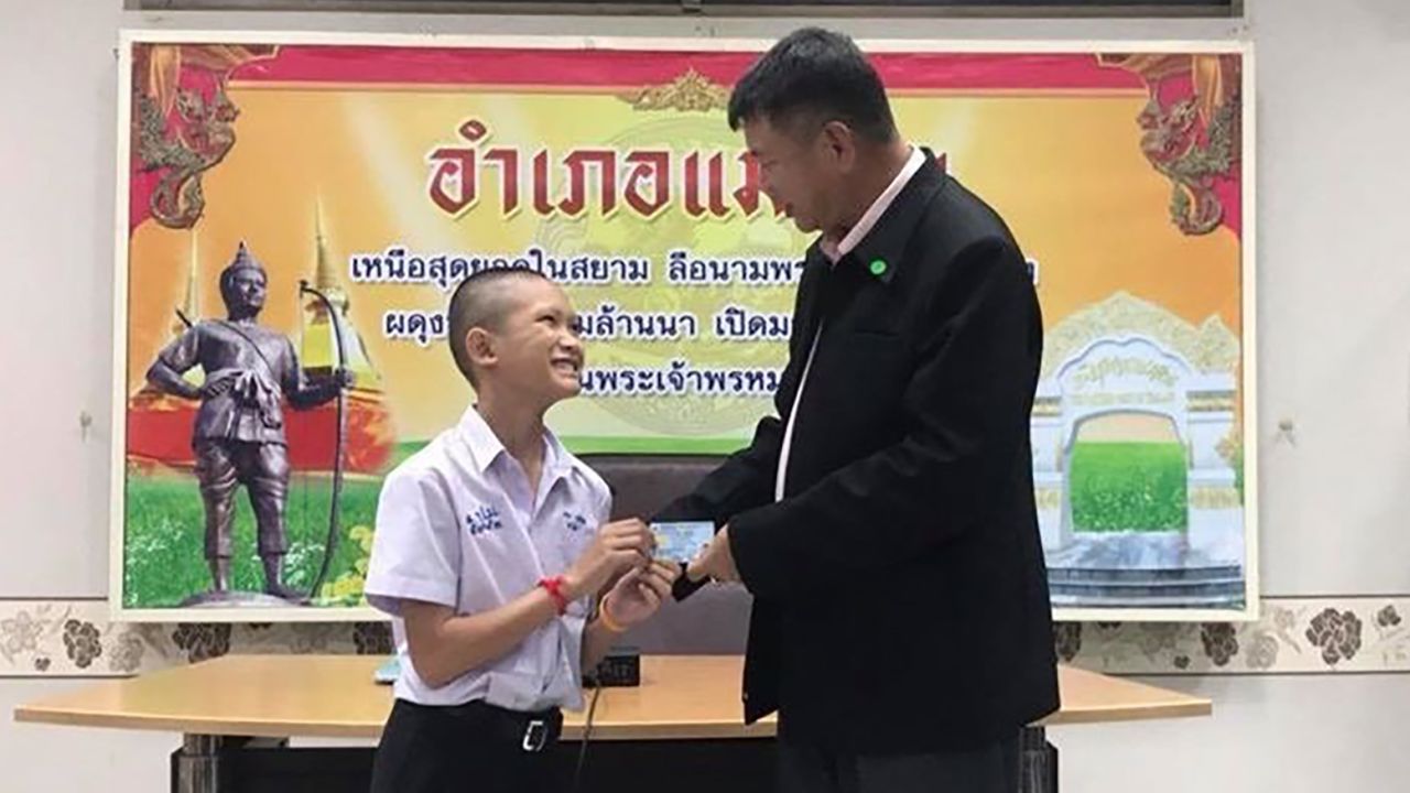 13-year-old Mongkol Boonpiam receives his Thai ID card, denoting Thai citizenship, from the Mae Sai district chief.