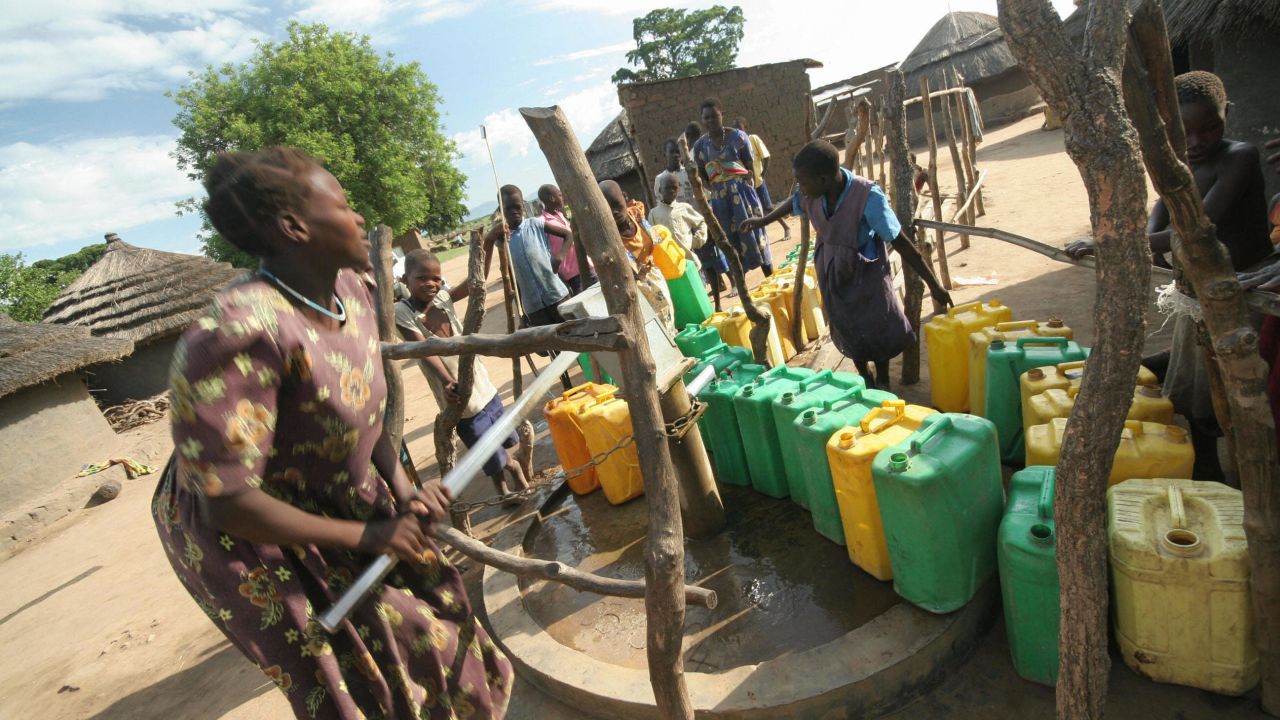 A woman pumps water from a borehole in an internally displaced people's (IDP) camp in Uganda. 