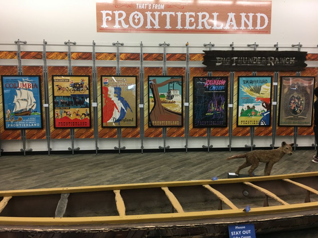 Frontierland posters provide a backdrop for a Davy Crockett Explorer Canoe, which guests rode around Pirate's Lair on Tom Sawyer's Island. Auction estimate: $6,000-$8.000.