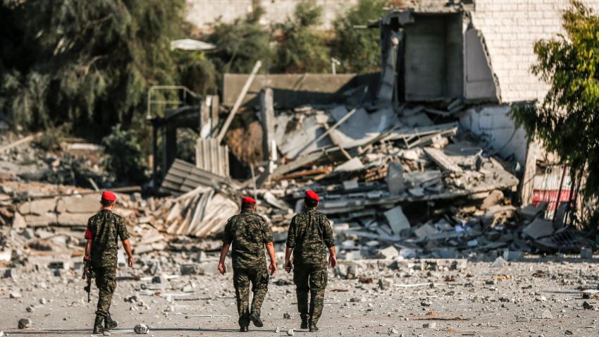 TOPSHOT - Members of Hamas' military police walk through a site that was hit by Israeli air strikes in Gaza City on August 9, 2018. (Photo by MAHMUD HAMS / AFP)        (Photo credit should read MAHMUD HAMS/AFP/Getty Images)