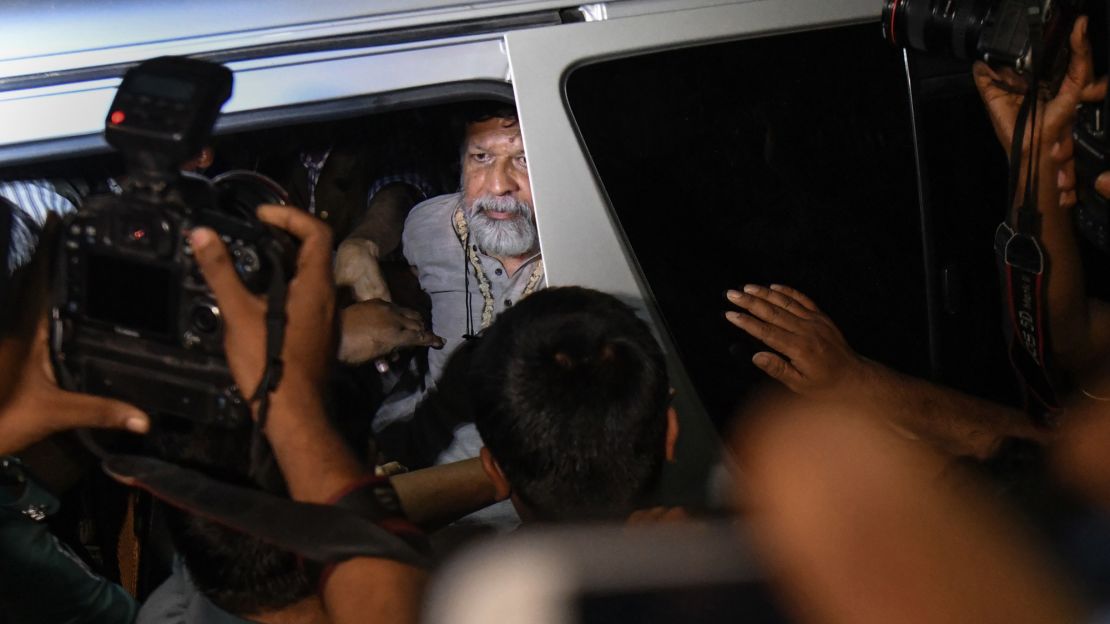 Activists and photographer Shahidul Alam looks out from a vehicle as he arrives for an appearance in a court in Dhaka on Monday.