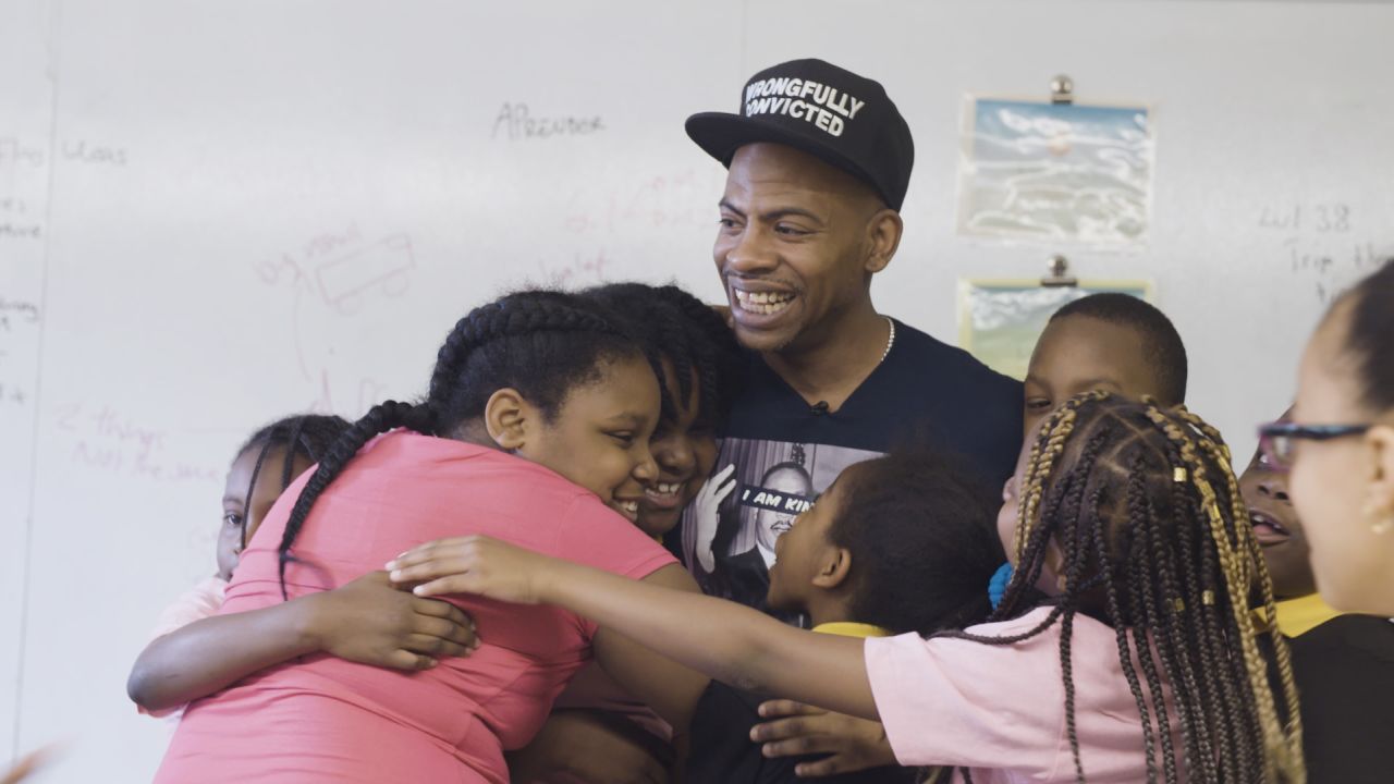 Bunn receives hugs from third-graders after leading a class at Ember Charter School.