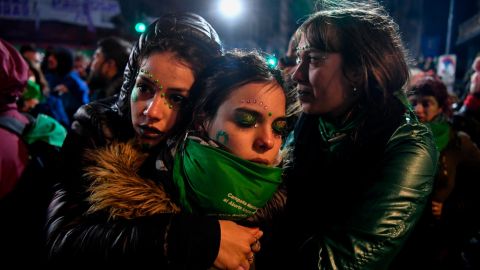 Activists in favor of legalizating abortion comfort each other outside the National Congress.