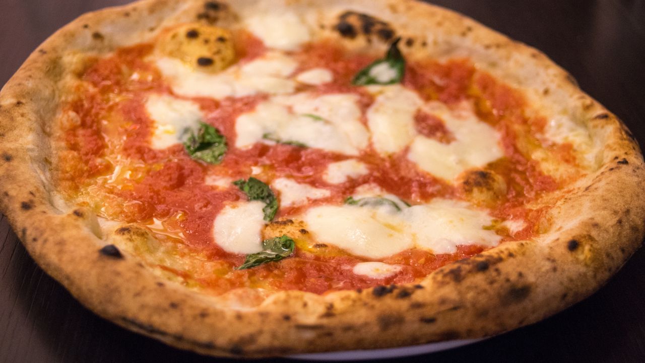 <strong>9. Pizza margherita in Naples, Italy.</strong> Legend has it that the margherita pizza was born when a baker prepared three pizzas for dinner for the visiting King Umberto and Queen Margherita. As the queen preferred the simply-prepared fresh mozz and basil pie, it now bears her name. 