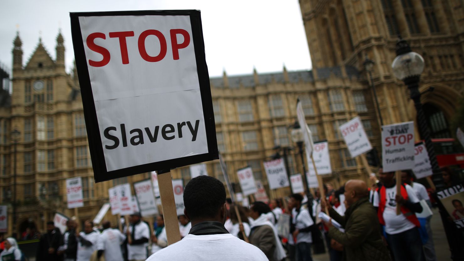 Anti-slavery activists rally outside Parliament on October 18, 2013 in London, England.
