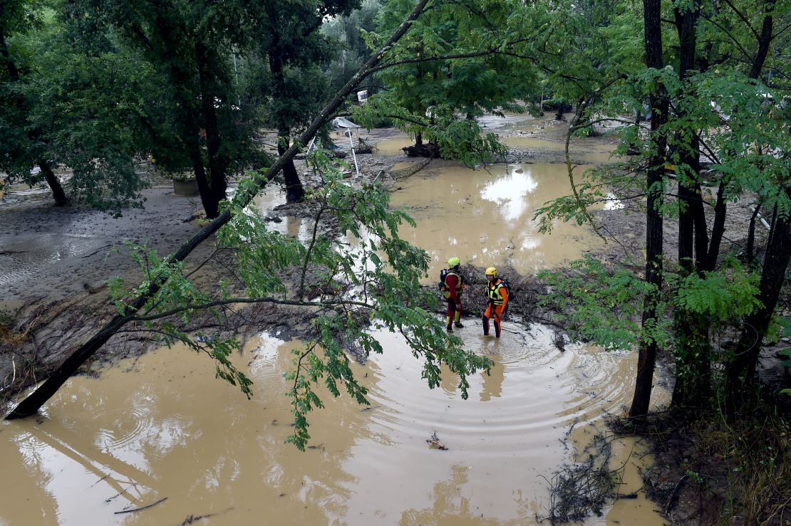 Rescuers stand in a flooded area near Saint-Julien-de-Peyrolas, southern France.