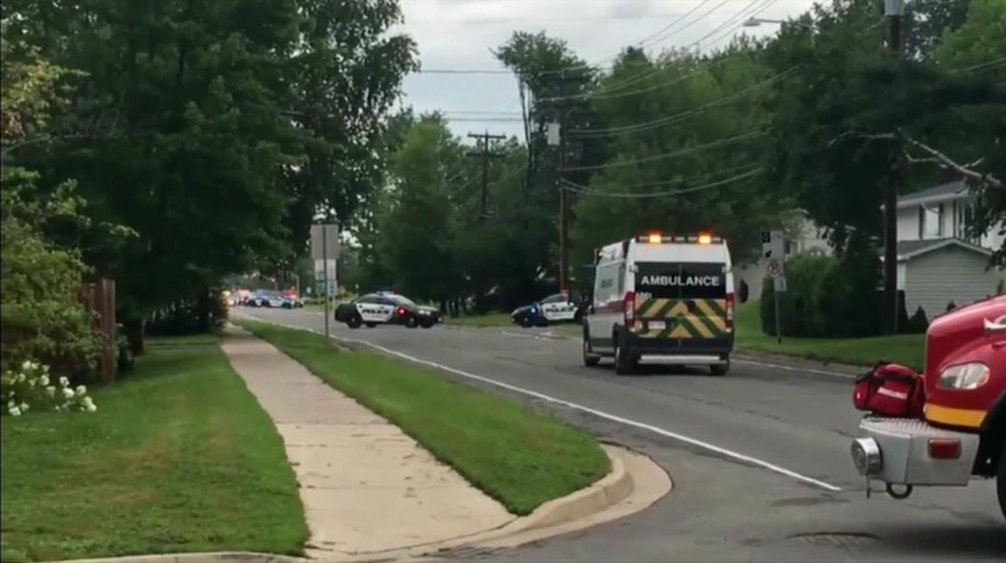 A screen grab from video at the shooting scene shows emergency vehicles on a residential street.