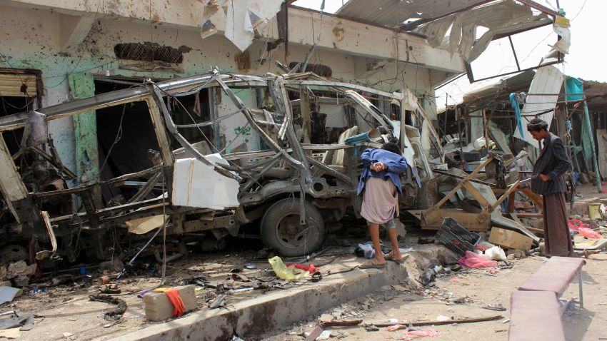 Yemenis gather next to the destroyed bus at the site of a Saudi-led coalition air strike, that targeted the Dahyan market the previous day in the Huthi rebels' stronghold province of Saada on August 10, 2018. - An attack on a bus at a market in rebel-held northern Yemen killed at least 29 children Thursday, the Red Cross said, as the Saudi-led coalition faced a growing outcry over the strike. (Photo by STRINGER / AFP)        (Photo credit should read STRINGER/AFP/Getty Images)