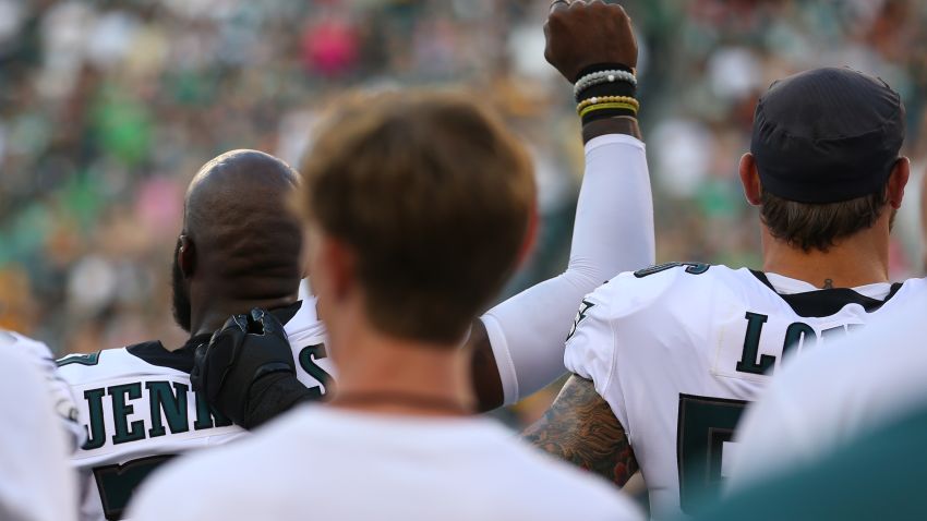 Malcolm Jenkins #27 of the Philadelphia Eagles raises his fist during the national anthem as Chris Long #56 puts his arm around him prior to the preseason game against the Pittsburgh Steelers at Lincoln Financial Field on August 9, 2018 in Philadelphia, Pennsylvania. The Steelers defeated the Eagles 31-14. Mitchell Leff/Getty Images