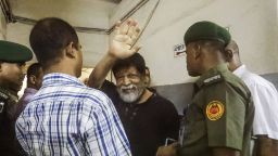 Renowned Bangladeshi photographer Shahidul Alam, 63, gestures in a hospital in Dhaka on August 8, 2018. - An award-winning photographer who accused Bangladesh officers of assaulting him after his arrest during major protests in Dhaka was back in police custody after a medical checkup, an official said on August 8. Shahidul Alam, 63, was detained by plainclothes police at his home Sunday after giving an interview to Al Jazeera about the student demonstrations, an arrest which drew condemnation from international rights groups. (Photo by - / AFP)        (Photo credit should read -/AFP/Getty Images)