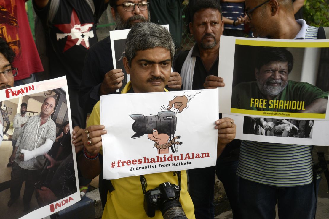 Indian journalist hold placards and take part in a silent demonstration Wednesday to protest against attack on journalists and the arrest of renowned Bangladeshi photographer and activist Shahidul Alam in Dhaka.