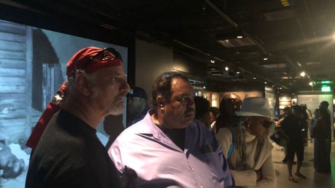 Daryl Davis and Preston watch a video on slavery inside the museum. 