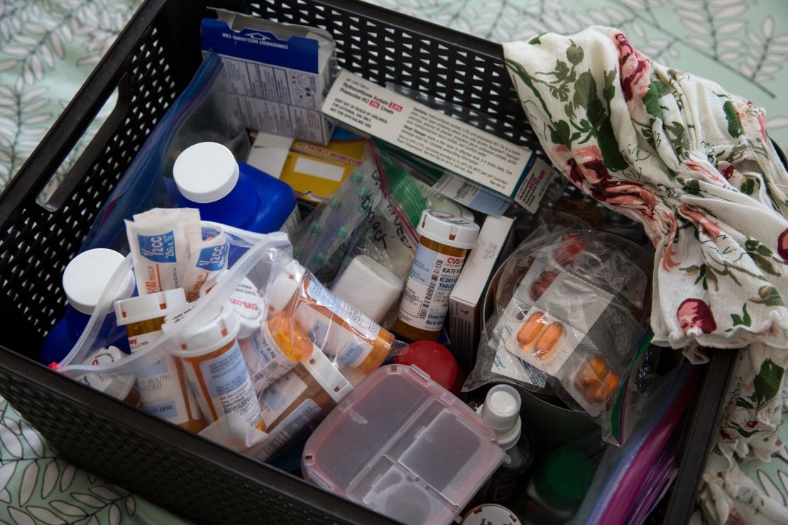 A basket filled with various medications stands as a reminder of Weissman's cancer battle. 