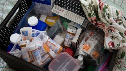 A basket filled with various medications stands as a reminder of Weissman's cancer battle. 