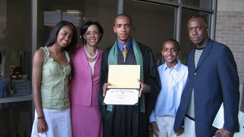 Clint Smith in cap and gown with family at his high school graduation from The Awty International School in Houston.