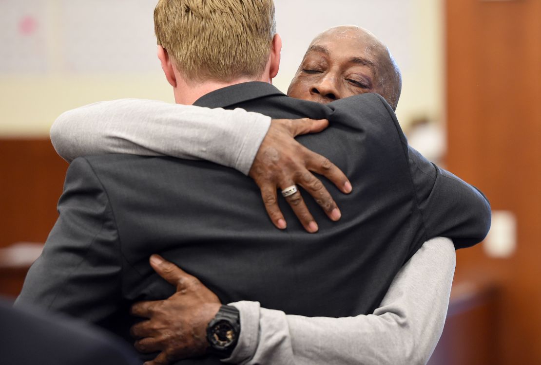 Johnson hugs one of his lawyers after the jury awarded him $289 million in damages.