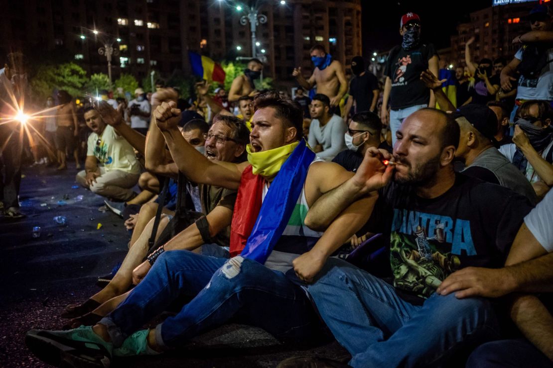 Romanians take part in a demonstration in front of the government headquarters in Bucharest on Friday.