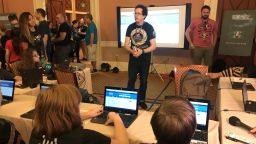 Children prepare to hack mock versions of state election websites at DEF CON on Friday. (Photo by Donie O'Sullivan/CNN)