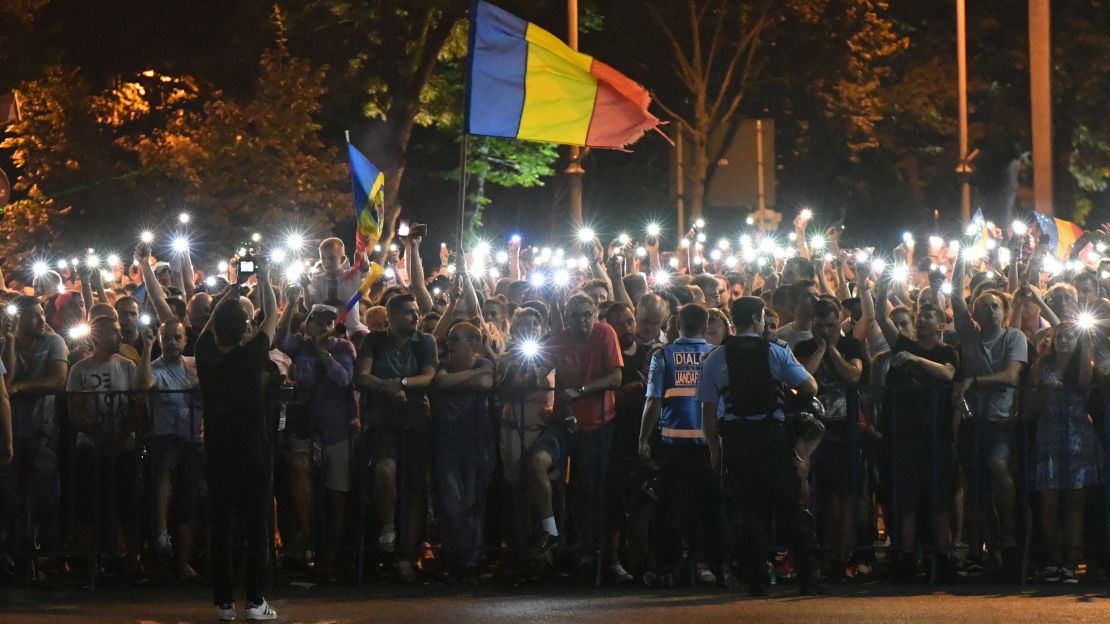 People wave Romanian national flags during Saturday's rally.