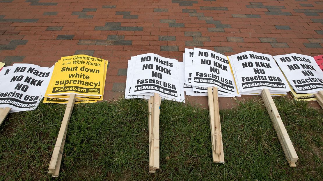 Anti-KKK signs are layed out by counterprotesters in Lafayette Park ahead of the planned white supremacist rally across from the White House.