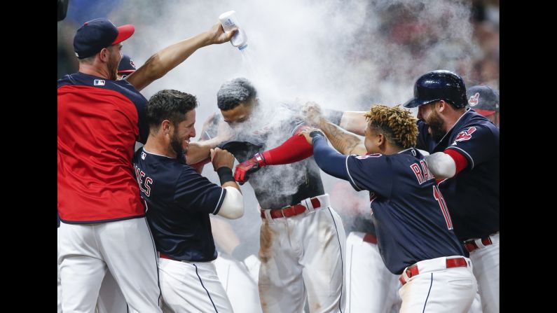 Francisco Lindor is mobbed by his Cleveland teammates after hitting a game-winning home run against Minnesota on Wednesday, August 8.