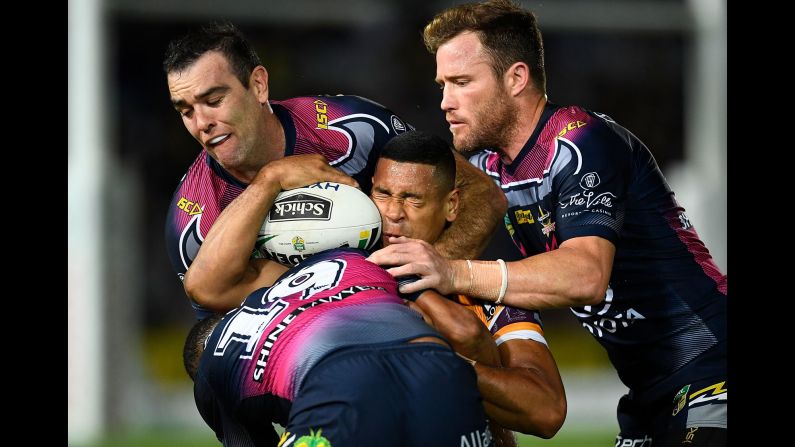 Brisbane's Jamayne Isaako is crunched by three of the North Queensland Cowboys during a rugby match in Townsville, Australia, on Thursday, August 9.