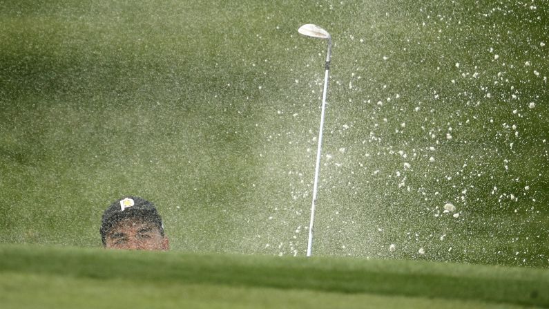 Rickie Fowler hits a shot out of the bunker during the first round of the PGA Championship in Town and Country, Missouri, on Thursday, August 9. 