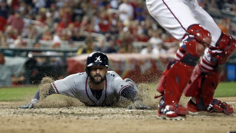 Atlanta Braves' Nick Markakis slides into home as Washington Nationals' catcher Matt Wieters waits for the throw on a two-run single during the ninth inning of the game on Tuesday, August 7, in Washington. The Braves won 3-1. 