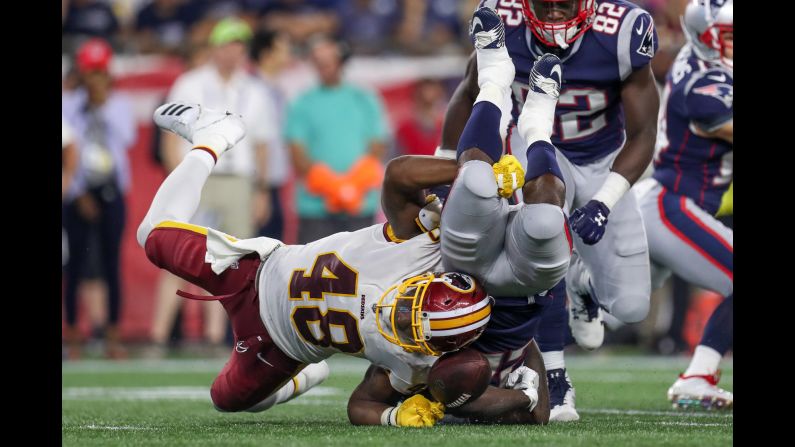 Washington Redskins linebacker Vontae Diggs tackles New England Patriots running back Ralph Webb during the fourth quarter on Thursday, August 9, in Foxborough, Massachusetts. 
