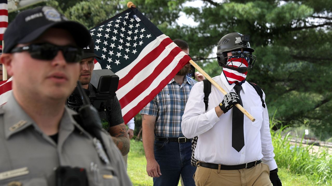 Police escort white supremacists to a metro station before the rally on August 12, 2018.