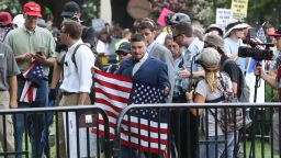 WASHINGTON, DC - AUGUST 11: Jason Kessler (C), who organized the rally, carries an American flag as white supremacists, neo-Nazis, members of the Ku Klux Klan and other hate groups gather for the Unite the Right rally in Lafayette Park across from the White House August 12, 2018 in Washington, DC. Thousands of protesters are expected to demonstrate against the "white civil rights" rally, which was planned by the organizer of last year's deadly rally in Charlottesville, Virginia.