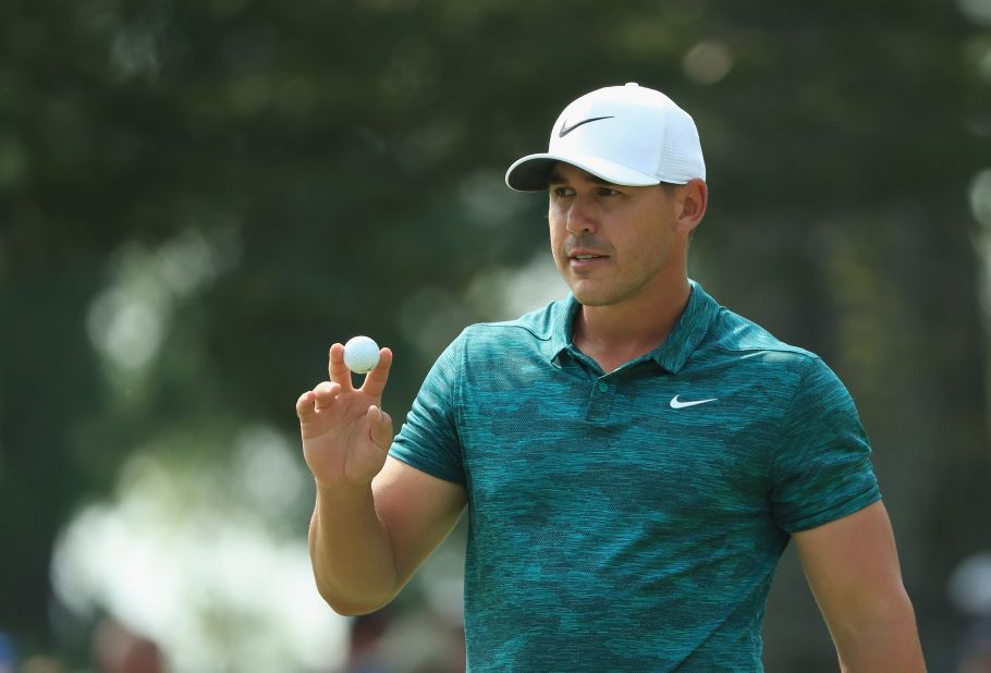 Brooks Koepka of the United States acknowledges the crowd after making a putt for birdie on the ninth green during his triumphant final round of the 2018 PGA Championship at Bellerive Country Club.