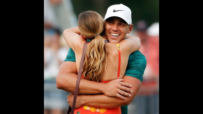 Brooks Koepka hugs his girlfriend, Jena Sims, after Koepka won the PGA Championship golf tournament at Bellerive Country Club on Sunday, August 12, outside St. Louis.