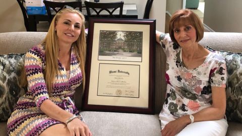 Melissa Howard holds a framed diploma, but Miami University suggests it's not real.