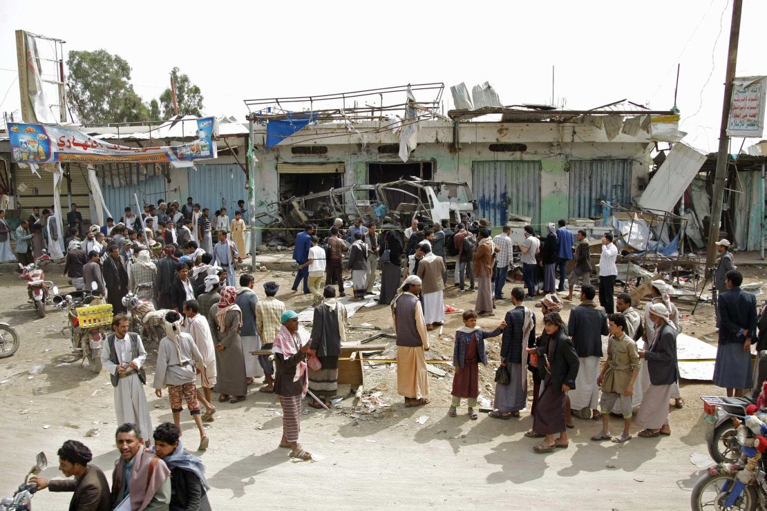 People gather on August 12 at the site of the deadly airstrike in Saada.