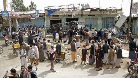 People gather on August 12 at the site of the deadly airstrike in Saada.