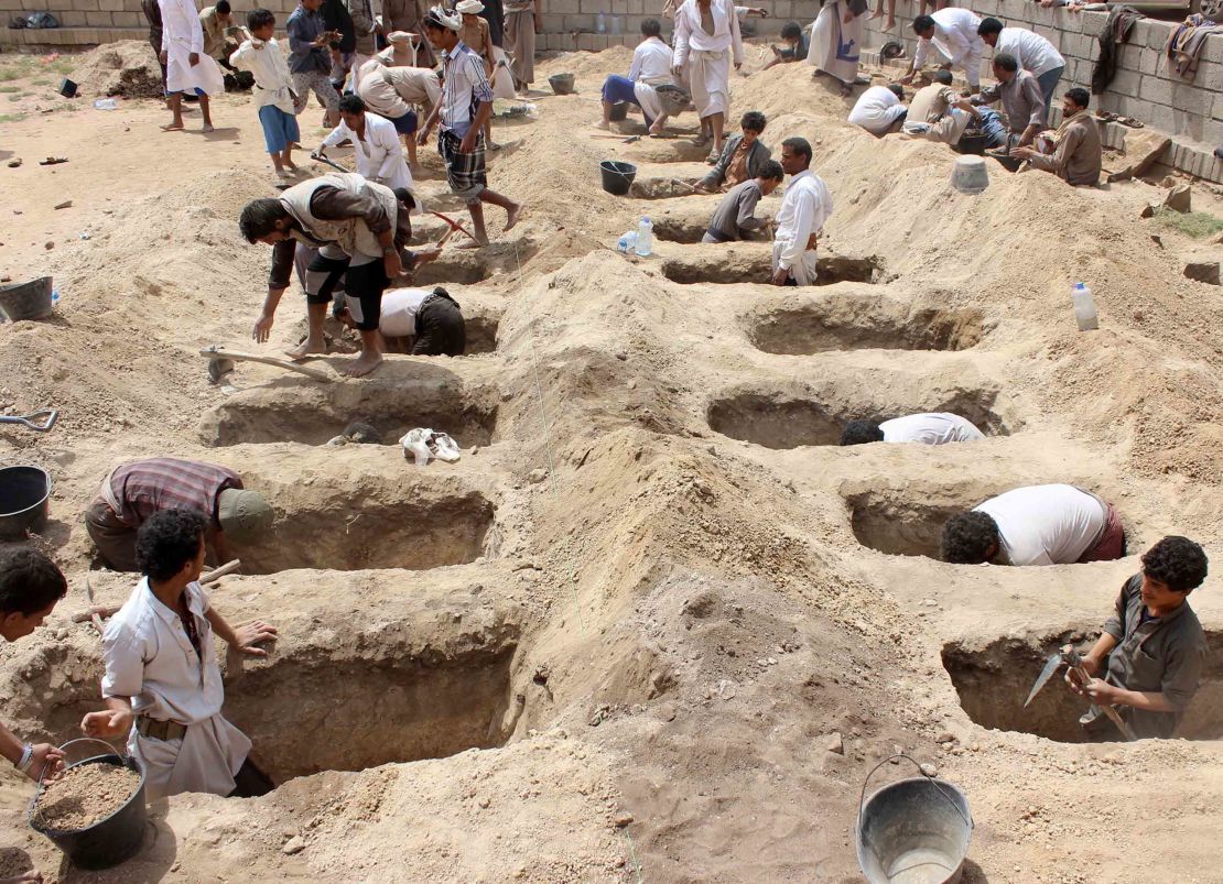 Yemenis dig graves for the children last week.