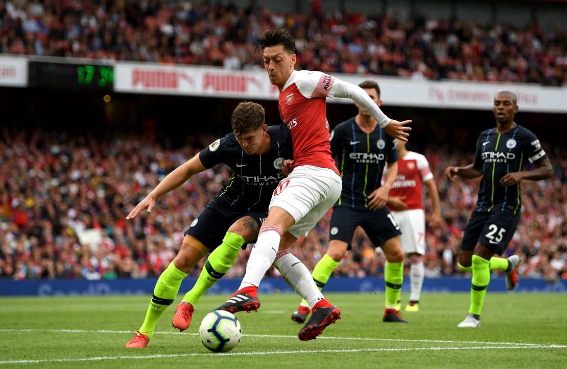 Arsenal's Mesut Ozil wears the "Visit Rwanda" logo on the sleeve during the team's season opener.