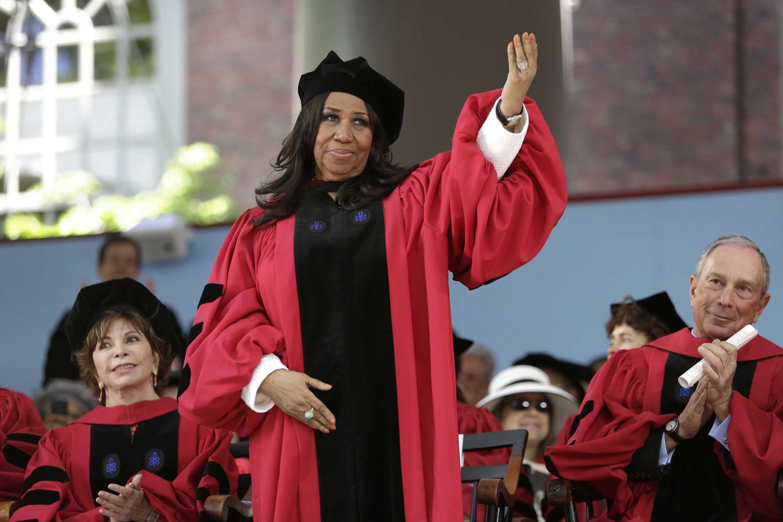 Franklin waves while standing to receive an honorary Doctor of Arts degree from Harvard University in 2014.