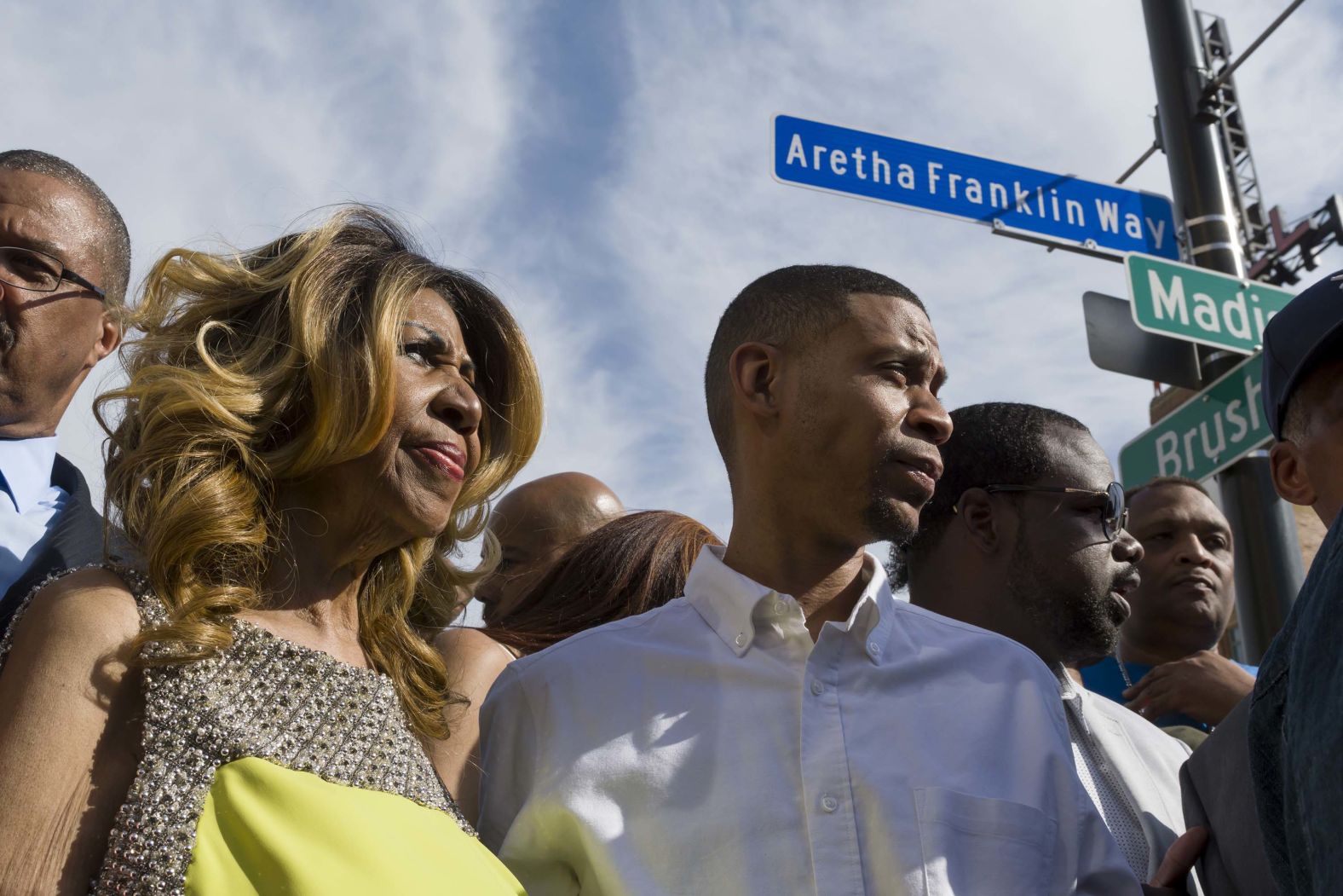 Franklin and her son Kecalf Cunningham stand under a newly unveiled street sign named in her honor outside Detroit's Music Hall in 2017.