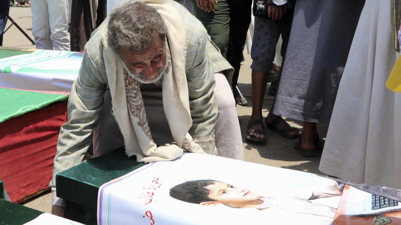 A Yemeni man mourns over a casket on August 13 during a mass funeral for children killed in an airstrike. 