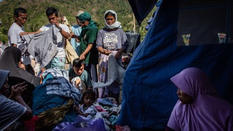 Villagers scramble for used clothing at temporary shelter in Pemenang in Lombok Island on August 12.