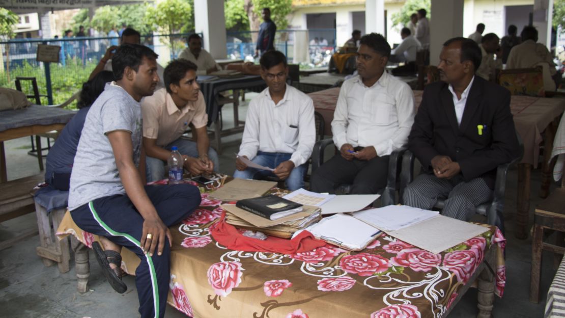 The staff of the local NGO, Jan Sahas operating in Bharatpur, Rajasthan sitting outside the local court and parsing through case files with Tarachand Pohiya, a lawyer who works with them.