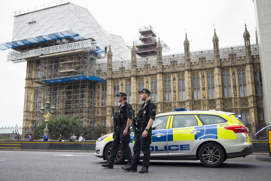 Police stand guard outside the Houses of Parliament following the incident.