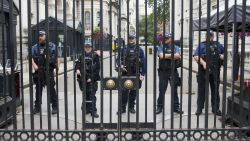 Police stand on alert at No.10 Downing Street in London, on Tuesday, August 14, after a car crashed into a barrier outside of the Houses of Parliament.