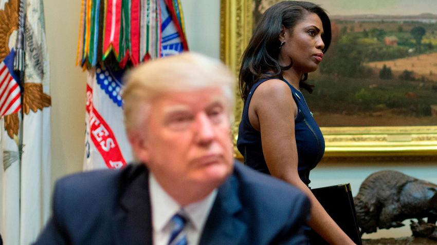 n this March 12, 2017 file photo, White House Director of communications for the Office of Public Liaison Omarosa Manigault, right, walks past President Donald Trump during a meeting on healthcare in the Roosevelt Room of the White House in Washington. (AP/Pablo Martinez Monsivais)